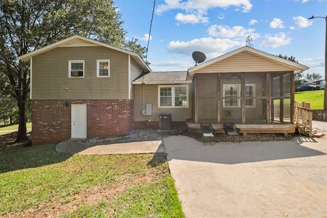 view of front of property with central air condition unit and a sunroom