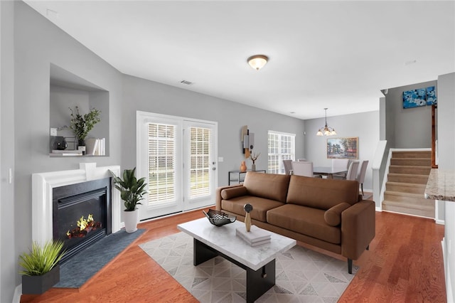 living room with a chandelier and light hardwood / wood-style floors