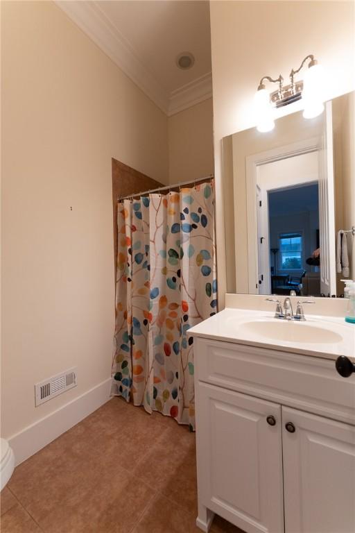 bathroom featuring crown molding, vanity, and a shower with shower curtain