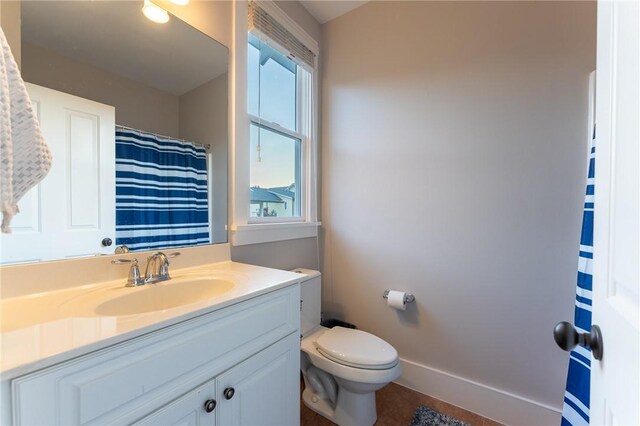 bathroom with vanity, toilet, and a wealth of natural light