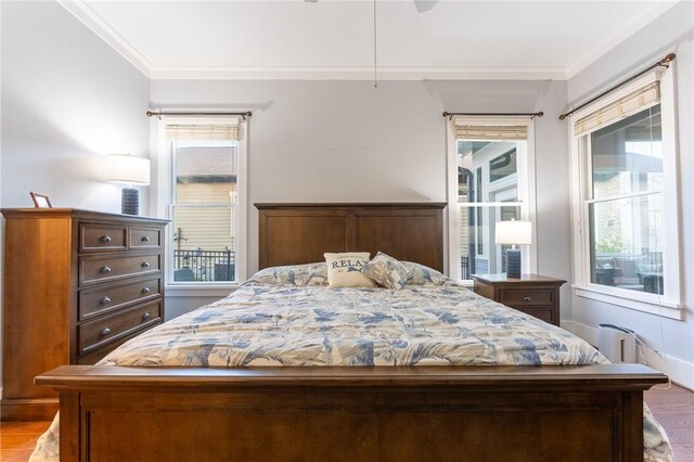 bedroom featuring ornamental molding and light hardwood / wood-style floors