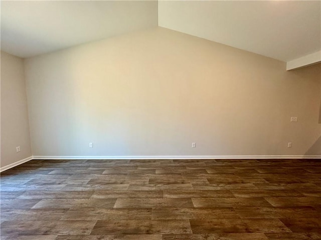 spare room with hardwood / wood-style floors and lofted ceiling