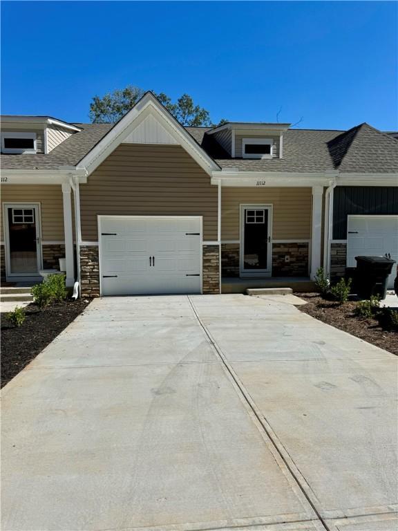 craftsman inspired home featuring a porch and a garage