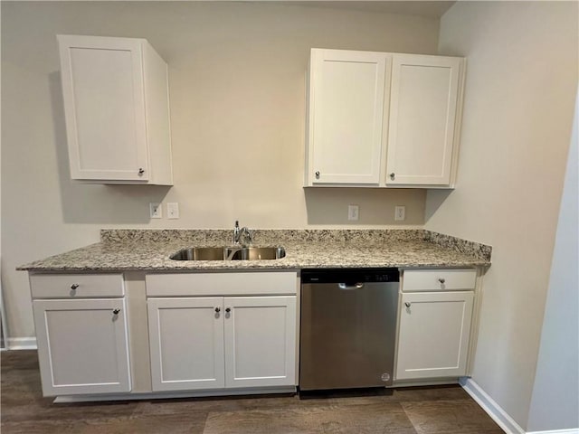 kitchen with dark hardwood / wood-style flooring, light stone counters, sink, dishwasher, and white cabinetry