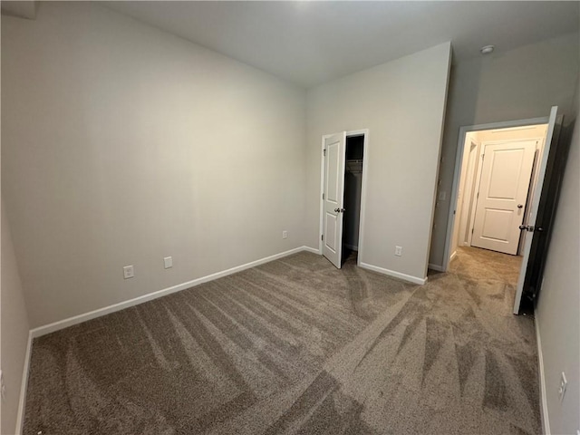 unfurnished bedroom with a closet and carpet flooring