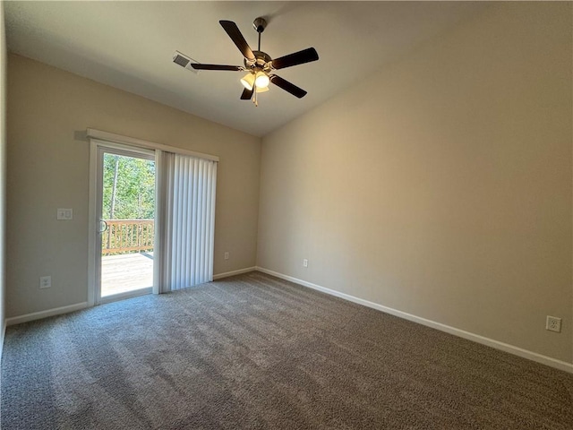 carpeted spare room featuring ceiling fan and vaulted ceiling