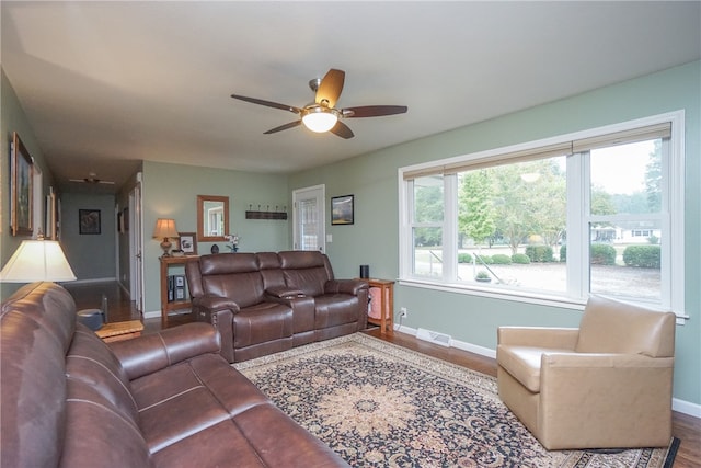 living room with ceiling fan, wood-type flooring, and a wealth of natural light