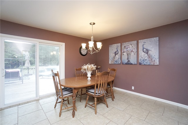 tiled dining room with a chandelier