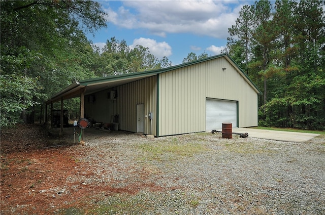 view of outdoor structure with a carport and a garage