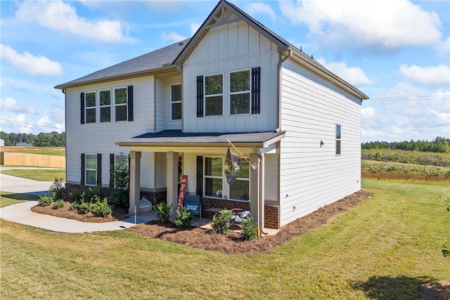 view of front facade featuring a front yard and covered porch