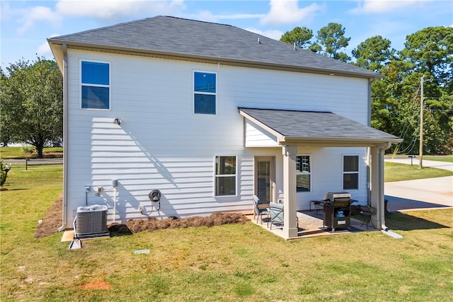 back of property featuring cooling unit, a yard, and a patio