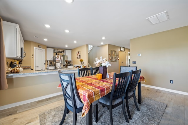 dining area featuring light hardwood / wood-style flooring and sink