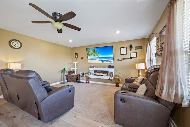 living room with ceiling fan and light hardwood / wood-style floors