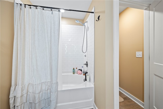 bathroom with wood-type flooring and shower / bath combo with shower curtain