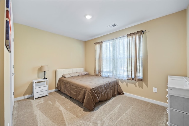 bedroom featuring light colored carpet