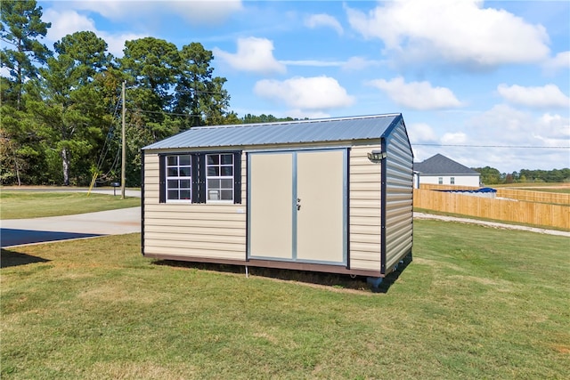 view of outbuilding featuring a lawn