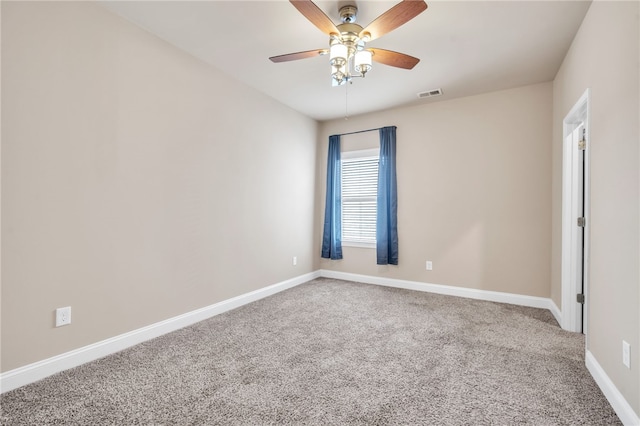 unfurnished room featuring carpet floors, a ceiling fan, visible vents, and baseboards