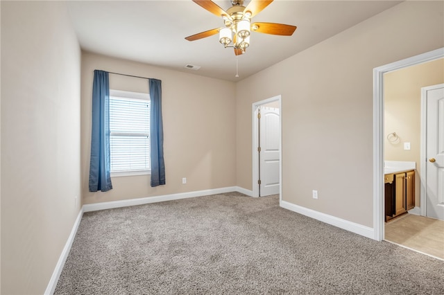 unfurnished bedroom with baseboards, visible vents, and light colored carpet