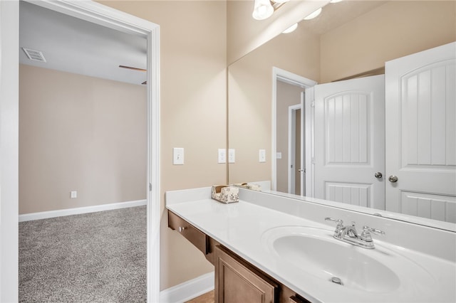 bathroom featuring visible vents, vanity, and baseboards