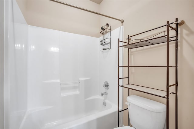 bathroom featuring shower / bathing tub combination and toilet