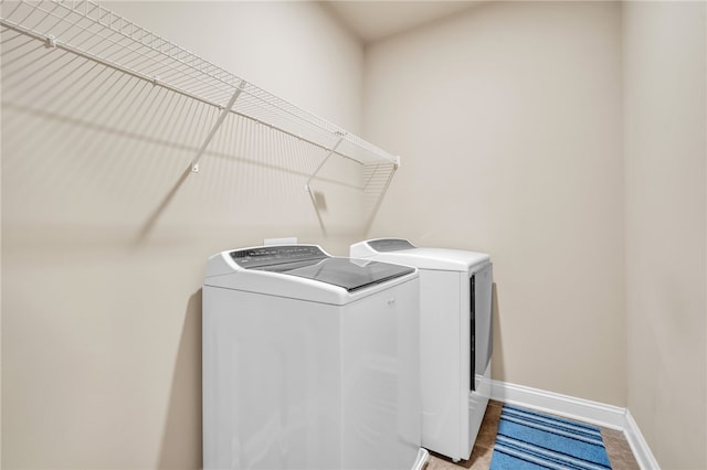 laundry room featuring laundry area, washer and clothes dryer, and baseboards