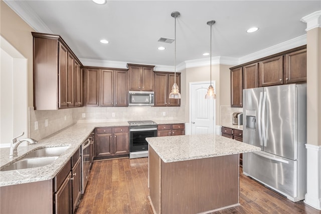 kitchen featuring ornamental molding, stainless steel appliances, dark wood-type flooring, and a sink