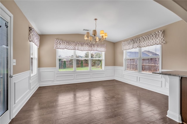 unfurnished dining area with an inviting chandelier, visible vents, vaulted ceiling, and dark wood-style flooring