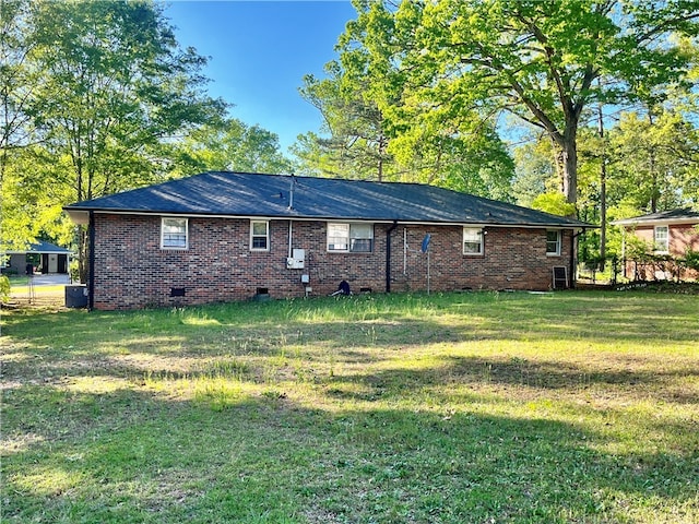 back of property featuring a lawn