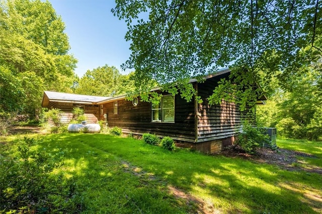 view of side of home with a lawn