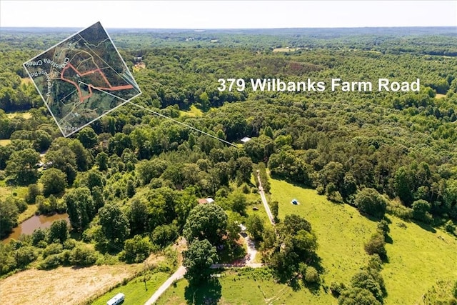 birds eye view of property with a wooded view