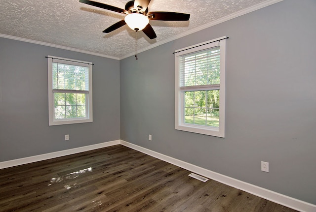 empty room featuring ceiling fan, crown molding, dark wood-type flooring, and a wealth of natural light