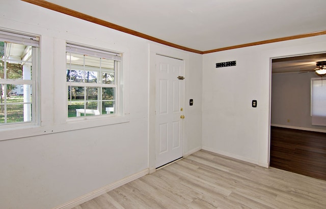 foyer with crown molding, ceiling fan, and light hardwood / wood-style flooring