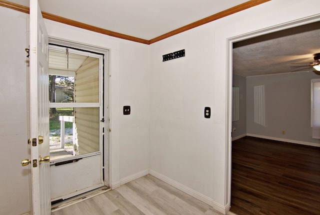 foyer entrance with lofted ceiling, ceiling fan, and light hardwood / wood-style floors