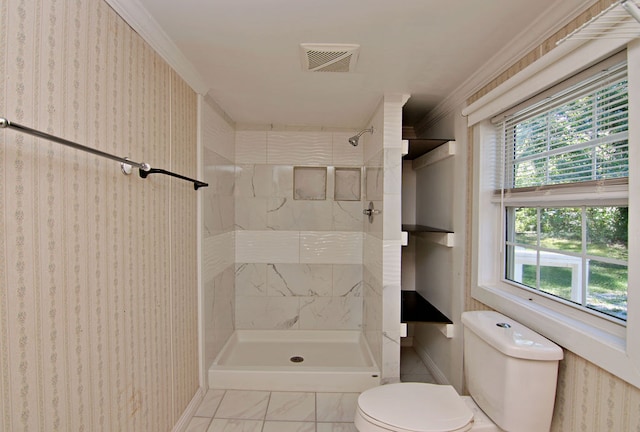 bathroom featuring ornamental molding, tile patterned floors, toilet, and tiled shower