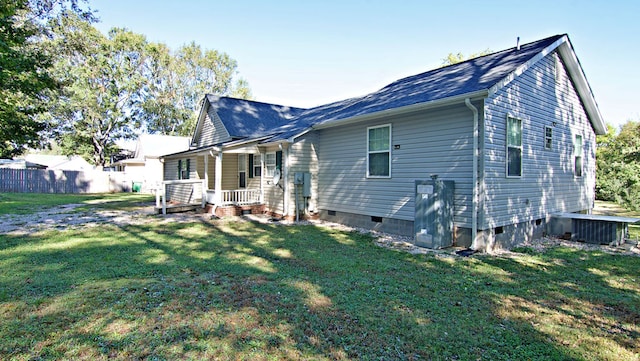 rear view of property with a lawn