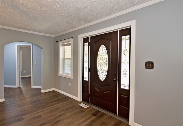 entryway with crown molding, dark hardwood / wood-style floors, and a textured ceiling