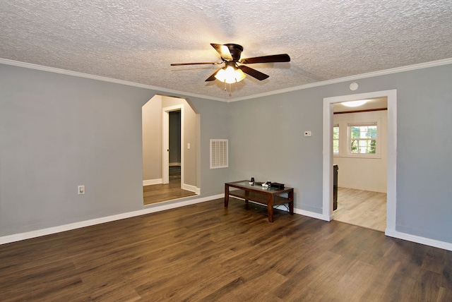 empty room featuring ceiling fan, dark hardwood / wood-style floors, and crown molding