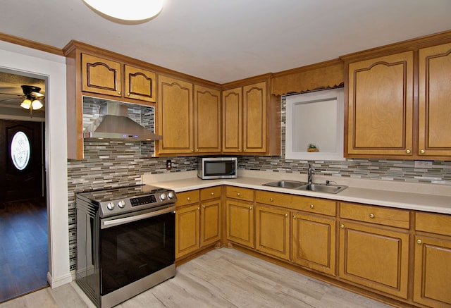 kitchen with light hardwood / wood-style floors, sink, stainless steel appliances, and backsplash