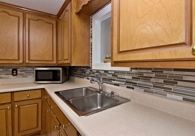 kitchen featuring backsplash and sink