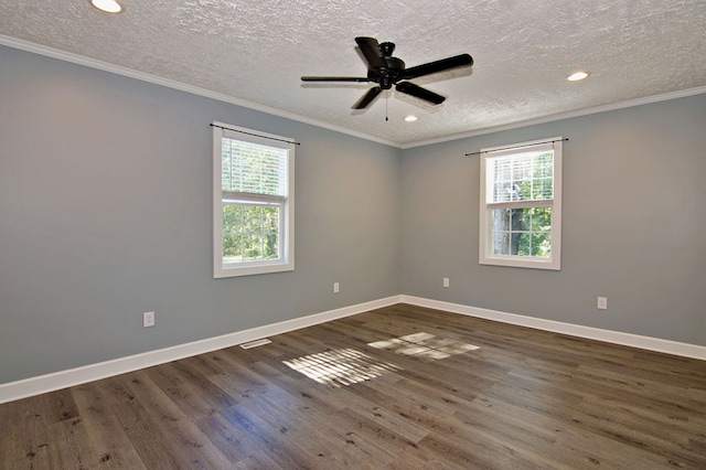 spare room with ceiling fan, a textured ceiling, plenty of natural light, and dark hardwood / wood-style floors