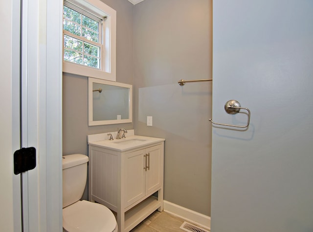 bathroom featuring tile patterned floors, vanity, and toilet