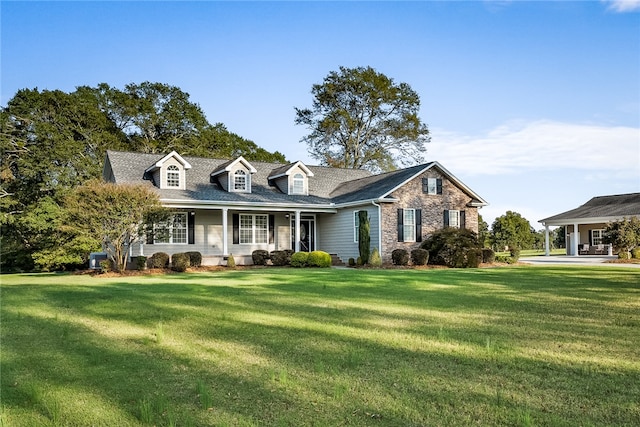 new england style home featuring a front lawn and a porch