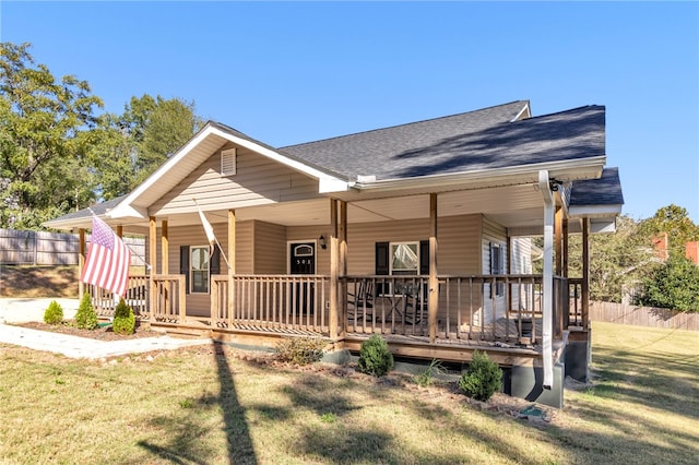 view of front of property with a porch and a front lawn