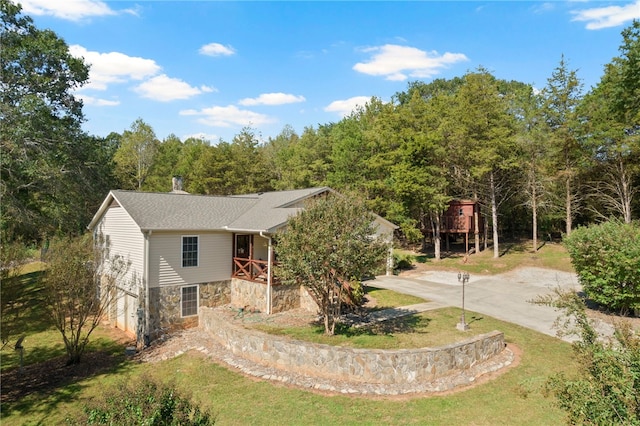 view of front of home featuring a front yard and a deck