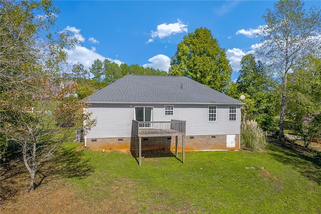 back of house with a lawn and a deck