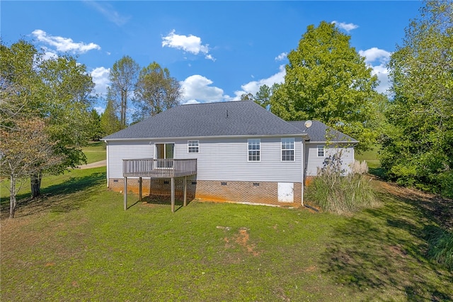 rear view of property featuring a deck and a lawn