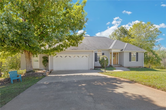 view of front of house with a front yard and a garage