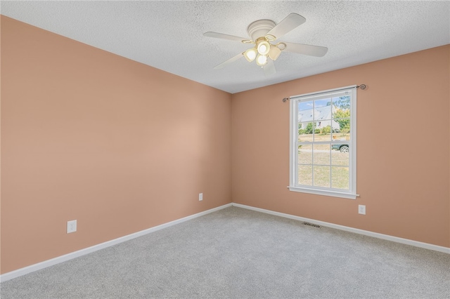 empty room with carpet, a textured ceiling, and ceiling fan