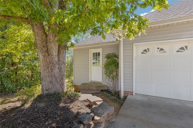 view of exterior entry with a garage