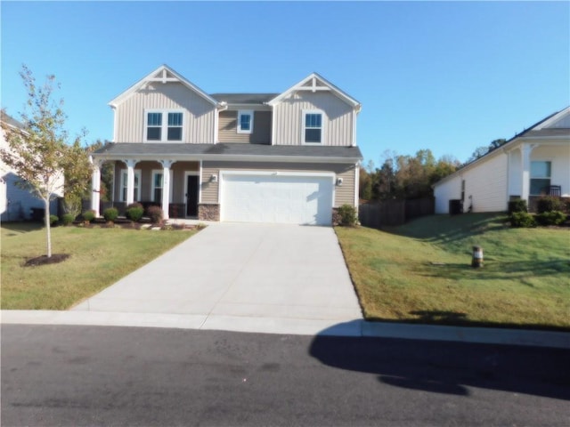 view of front of property featuring a front lawn and a garage